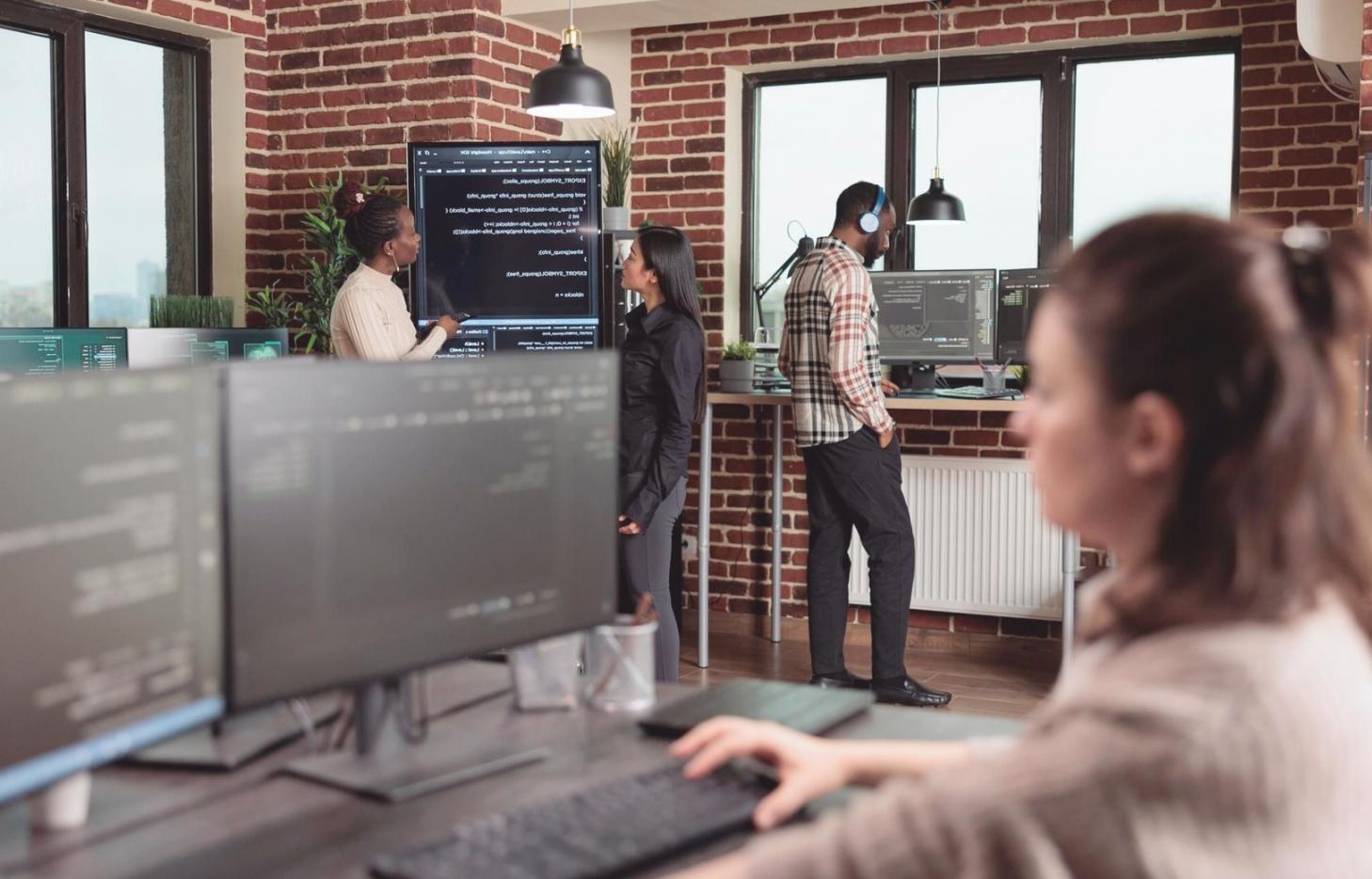 Early blockchain development workspace showing multiple monitors with code and network diagrams